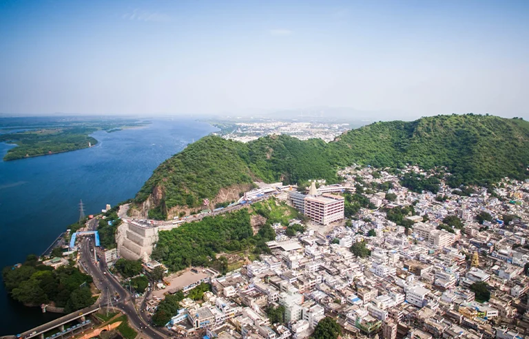 Prakasam Barrage with Vijayawada city skyline, a business and cultural hub.